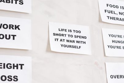 Motivational quotes on white paper promoting healthy habits and lifestyle changes.